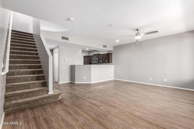 unfurnished living room with ceiling fan and hardwood / wood-style floors