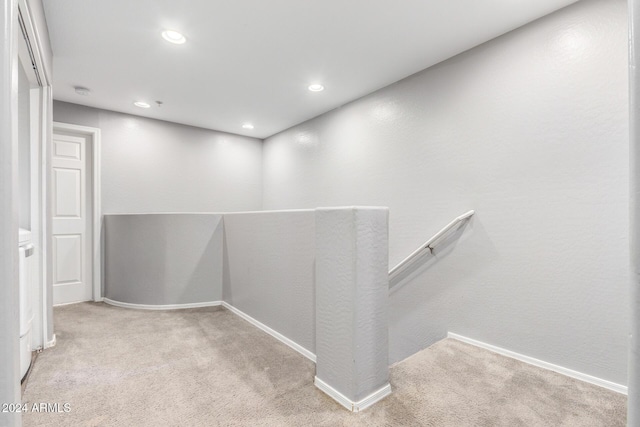 hallway with light colored carpet