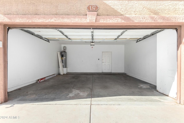 garage with electric water heater and a garage door opener