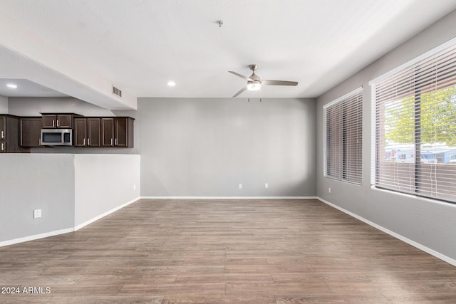 spare room featuring light wood-type flooring and ceiling fan