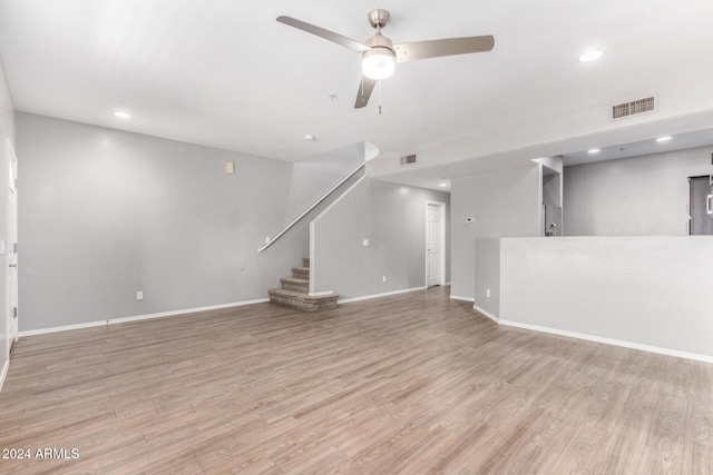 unfurnished living room with ceiling fan and light hardwood / wood-style floors