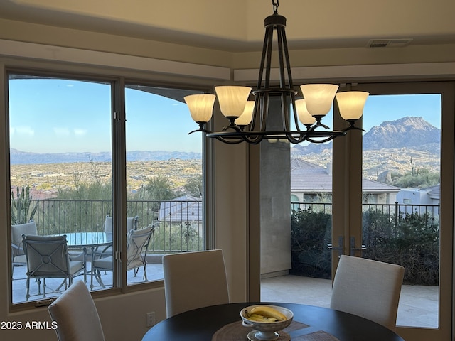 dining room featuring a mountain view and a chandelier