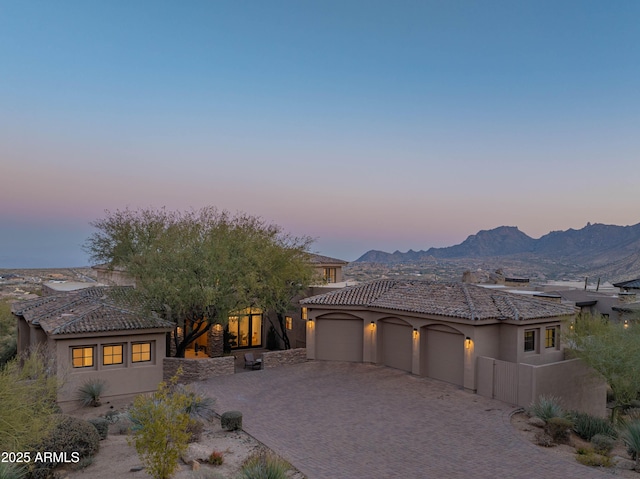 view of front of house with a garage and a mountain view