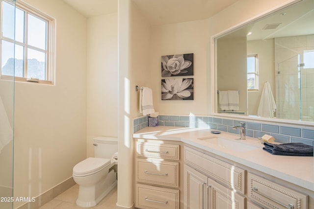 bathroom with tasteful backsplash, vanity, a shower with shower door, tile patterned floors, and toilet