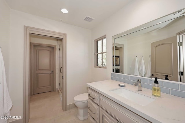 bathroom featuring vanity, tile patterned flooring, and toilet