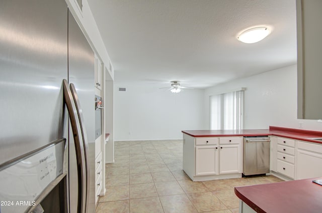 kitchen featuring white cabinetry, ceiling fan, kitchen peninsula, light tile patterned floors, and appliances with stainless steel finishes