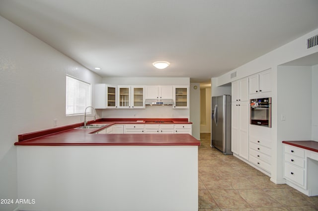 kitchen featuring white cabinets, appliances with stainless steel finishes, and sink