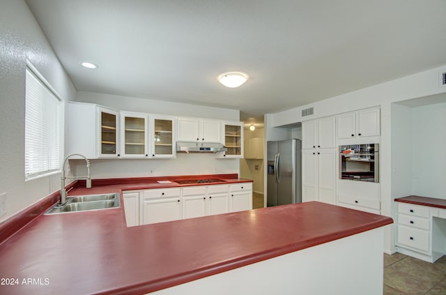 kitchen featuring white cabinets, sink, light tile patterned floors, and stainless steel appliances