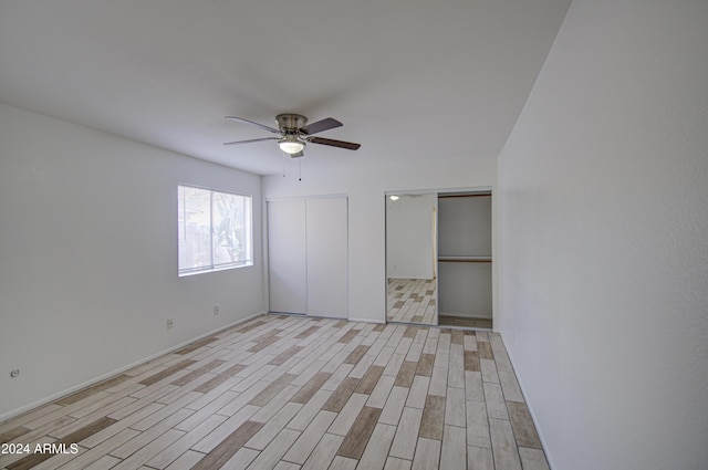 unfurnished bedroom featuring ceiling fan and light hardwood / wood-style flooring