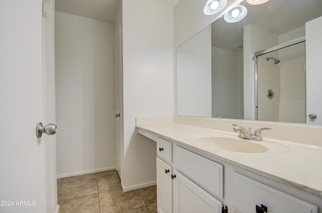 bathroom featuring tile patterned floors, a shower, and vanity