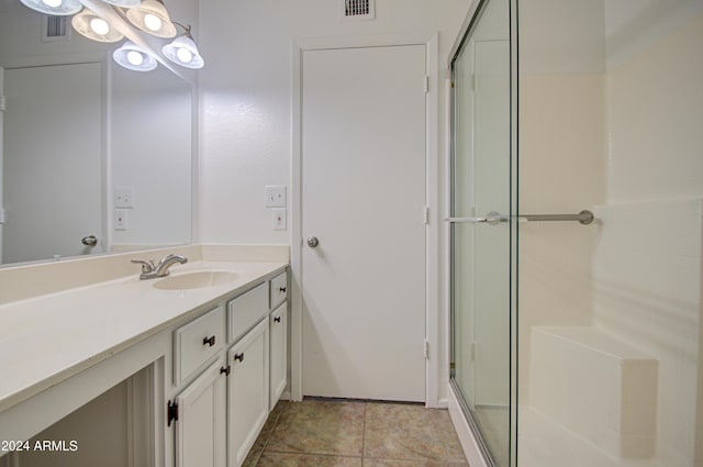 bathroom featuring tile patterned floors, vanity, and walk in shower