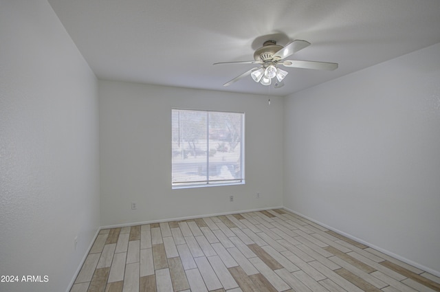 spare room featuring light wood-type flooring and ceiling fan