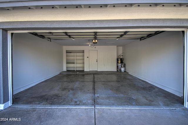 garage with gas water heater and a garage door opener