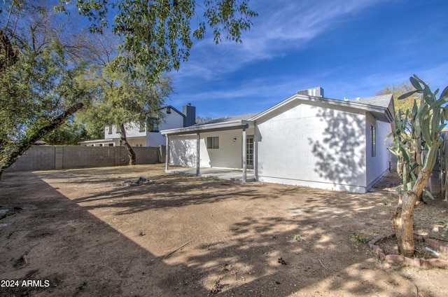 back of property with a patio