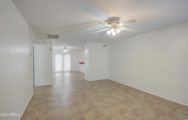 tiled spare room with ceiling fan