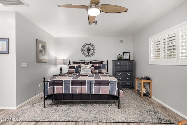 bedroom featuring wood finished floors, baseboards, and ceiling fan