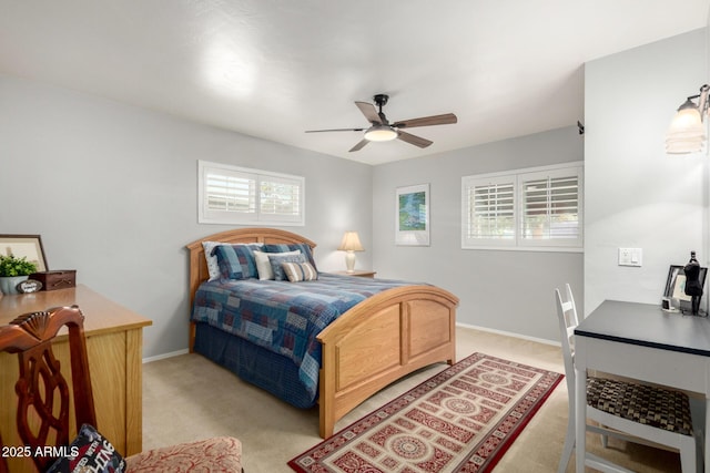 bedroom featuring light carpet, baseboards, and a ceiling fan