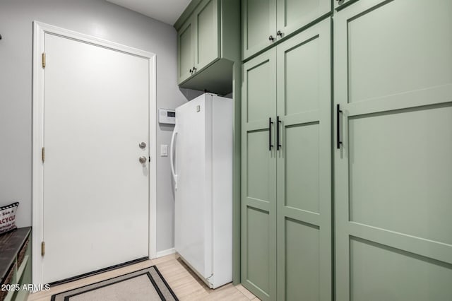 mudroom with light wood finished floors and baseboards