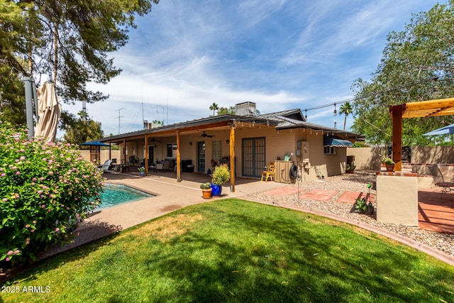 rear view of house featuring ceiling fan, a patio, and a chimney