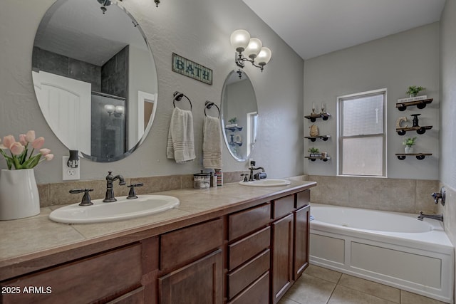 bathroom with tile patterned flooring, vanity, and plus walk in shower