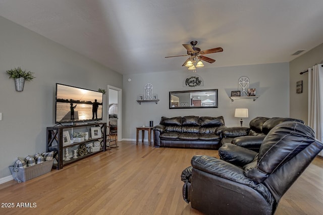 living room featuring ceiling fan and light hardwood / wood-style floors