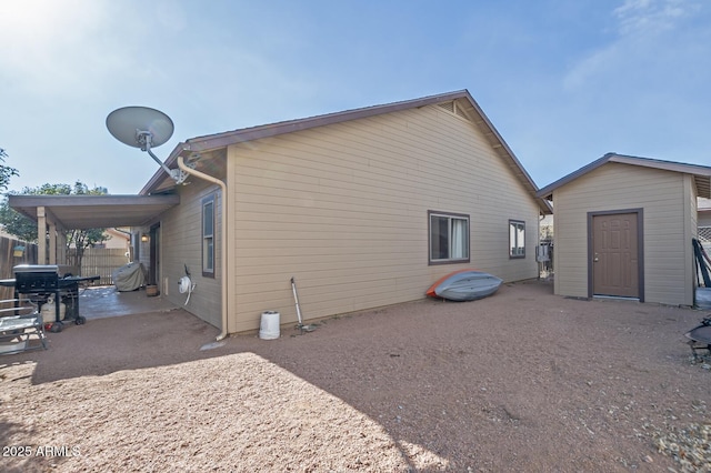 view of home's exterior with a storage shed