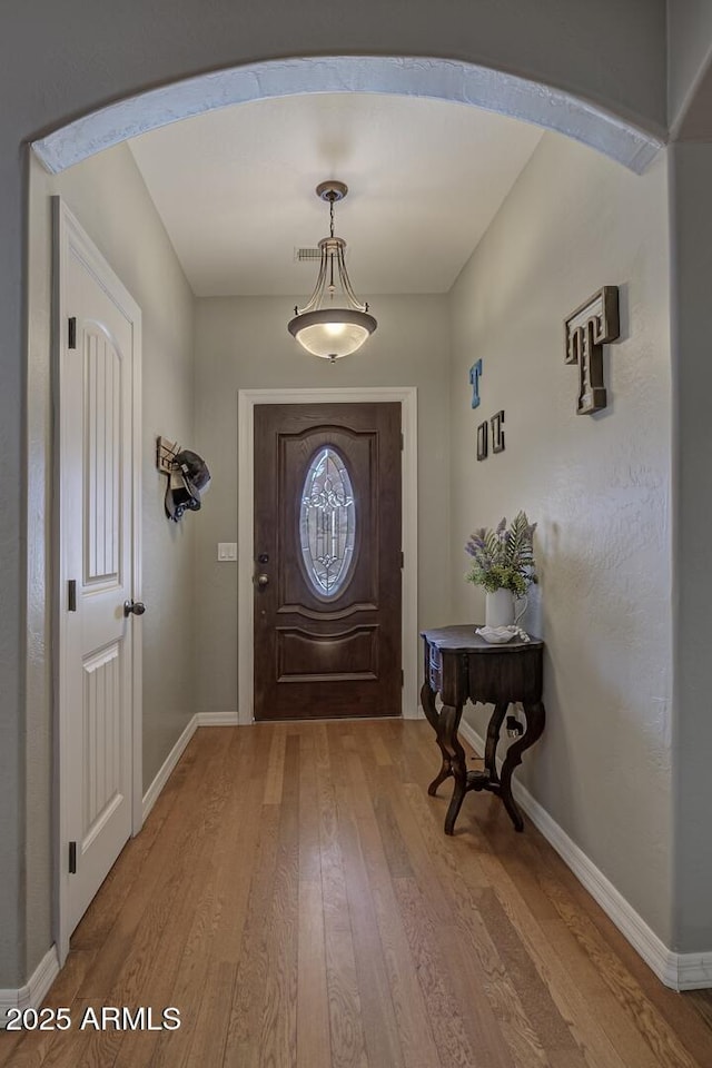 doorway to outside featuring wood-type flooring