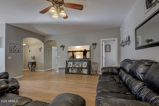 living room featuring light hardwood / wood-style floors and ceiling fan