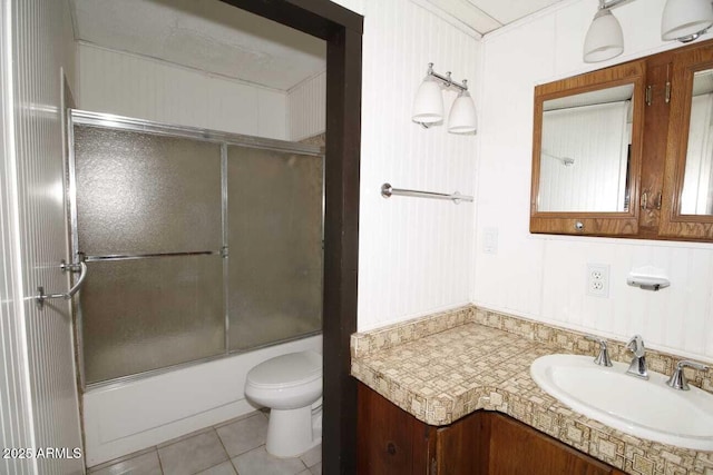 full bathroom featuring toilet, vanity, shower / bath combination with glass door, and tile patterned flooring