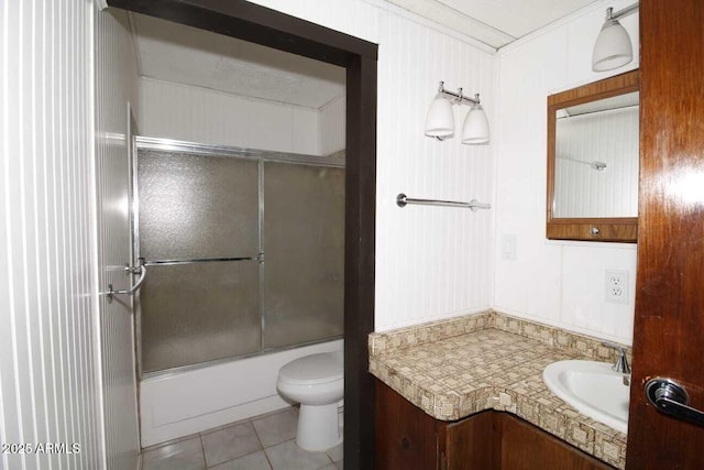 full bathroom featuring toilet, crown molding, bath / shower combo with glass door, vanity, and tile patterned flooring