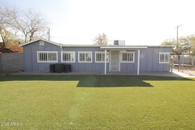 rear view of house with a yard