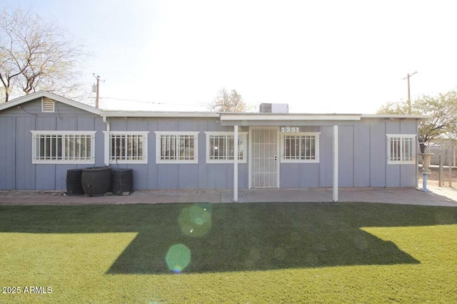 rear view of house with a lawn