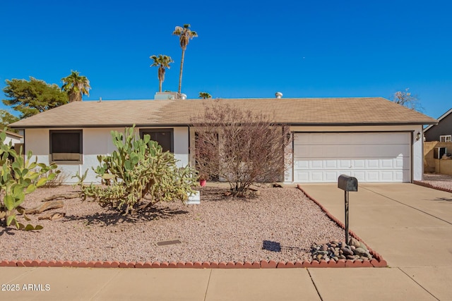 ranch-style home featuring concrete driveway, stucco siding, and an attached garage