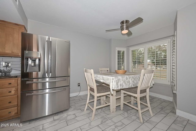 dining area with marble finish floor, ceiling fan, and baseboards