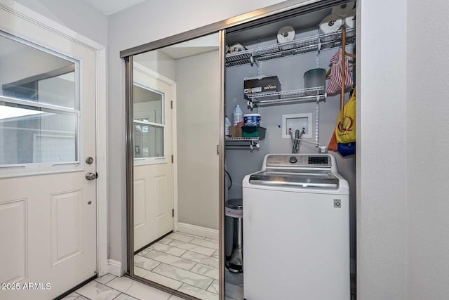 washroom with washer / clothes dryer, marble finish floor, baseboards, and laundry area