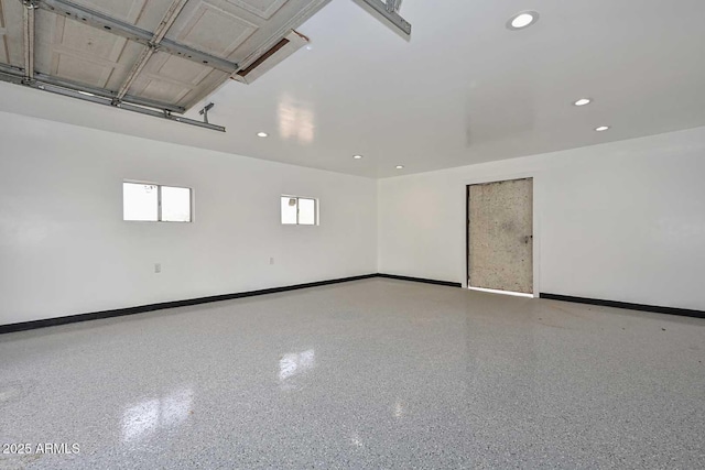 garage with baseboards and recessed lighting