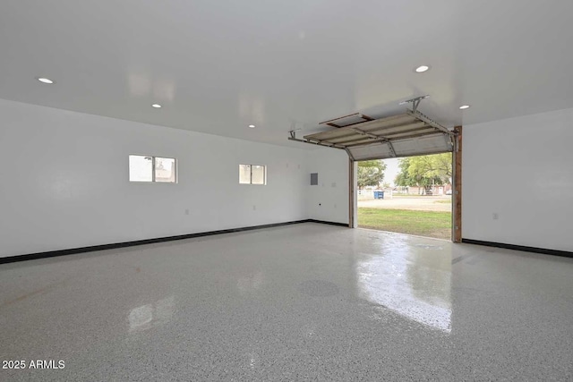 garage featuring recessed lighting and baseboards