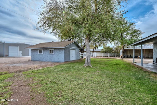 view of yard with fence and an outdoor structure