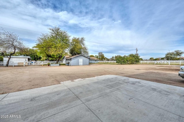 view of yard featuring an outbuilding and fence