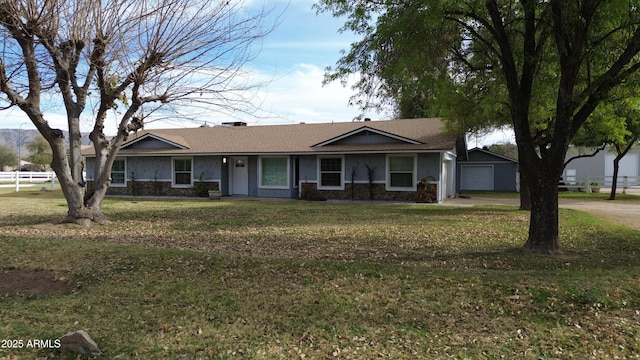 single story home with stone siding, fence, a front lawn, and stucco siding