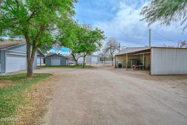 view of street featuring an outbuilding and driveway