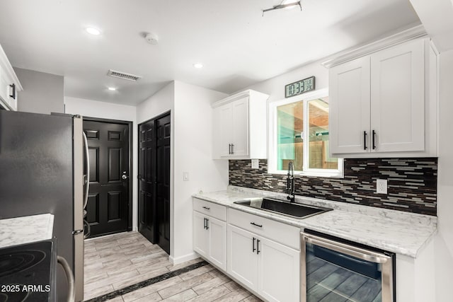 2109 E Gelding Dr, Phoenix, AZ 85022 - kitchen with backsplash, dishwashing machine, white cabinets, electric range, and wood tiled floors