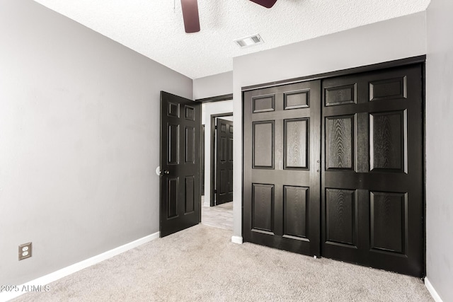 2109 E Gelding Dr, Phoenix, AZ 85022 - unfurnished bedroom featuring carpet flooring, a textured ceiling, a ceiling fan, and a closet