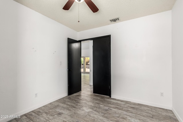 2109 E Gelding Dr, Phoenix, AZ 85022 - empty room featuring ceiling fan, a textured ceiling, and light wood-style floors