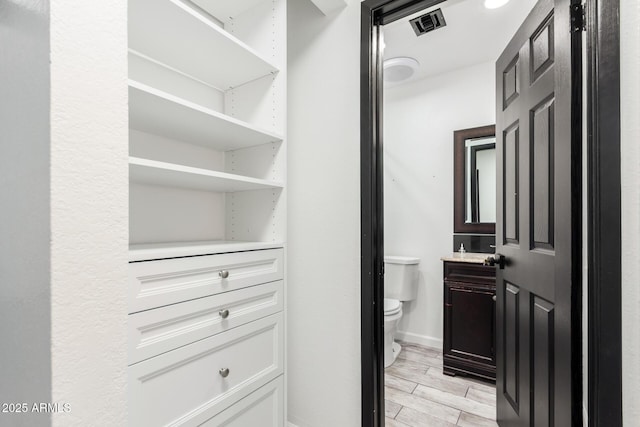 2109 E Gelding Dr, Phoenix, AZ 85022 - walk in closet featuring wood tiled floors