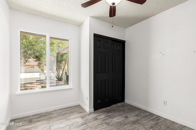 2109 E Gelding Dr, Phoenix, AZ 85022 - empty room with a ceiling fan, a textured ceiling, and wood finished floors