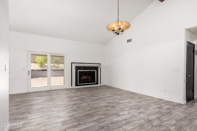 2109 E Gelding Dr, Phoenix, AZ 85022 - unfurnished living room with high vaulted ceiling, wood finished floors, a chandelier, and a fireplace