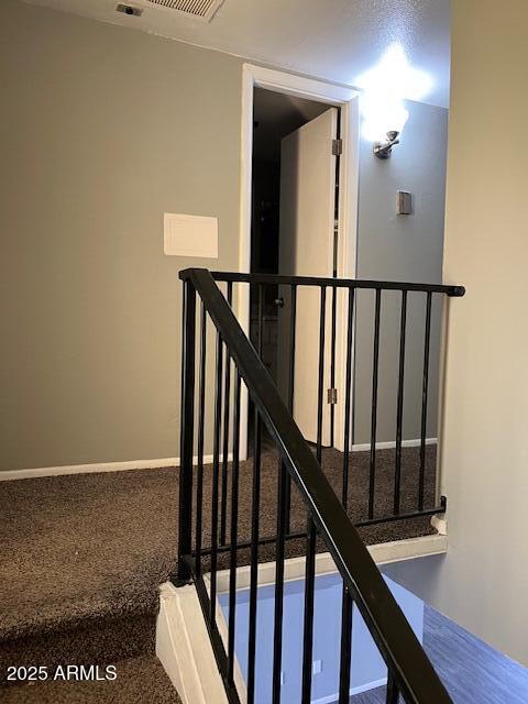 stairway with carpet and baseboards