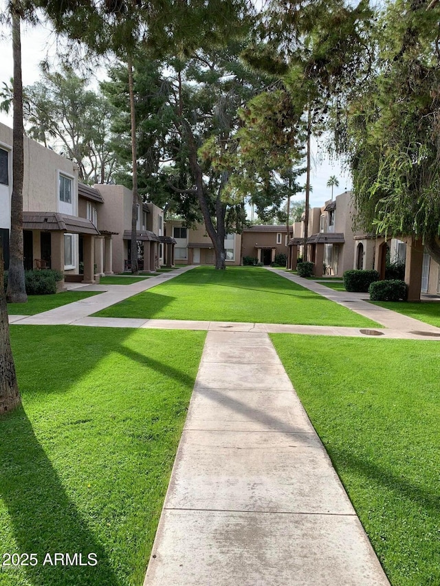 view of home's community with a residential view and a yard