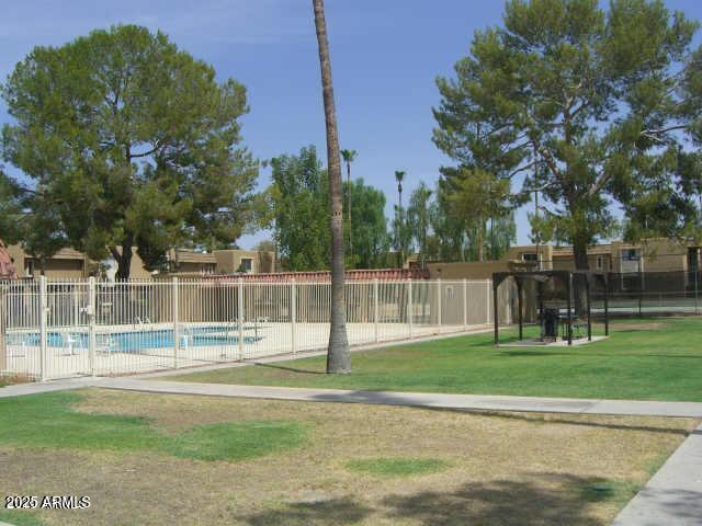 pool with a lawn and fence